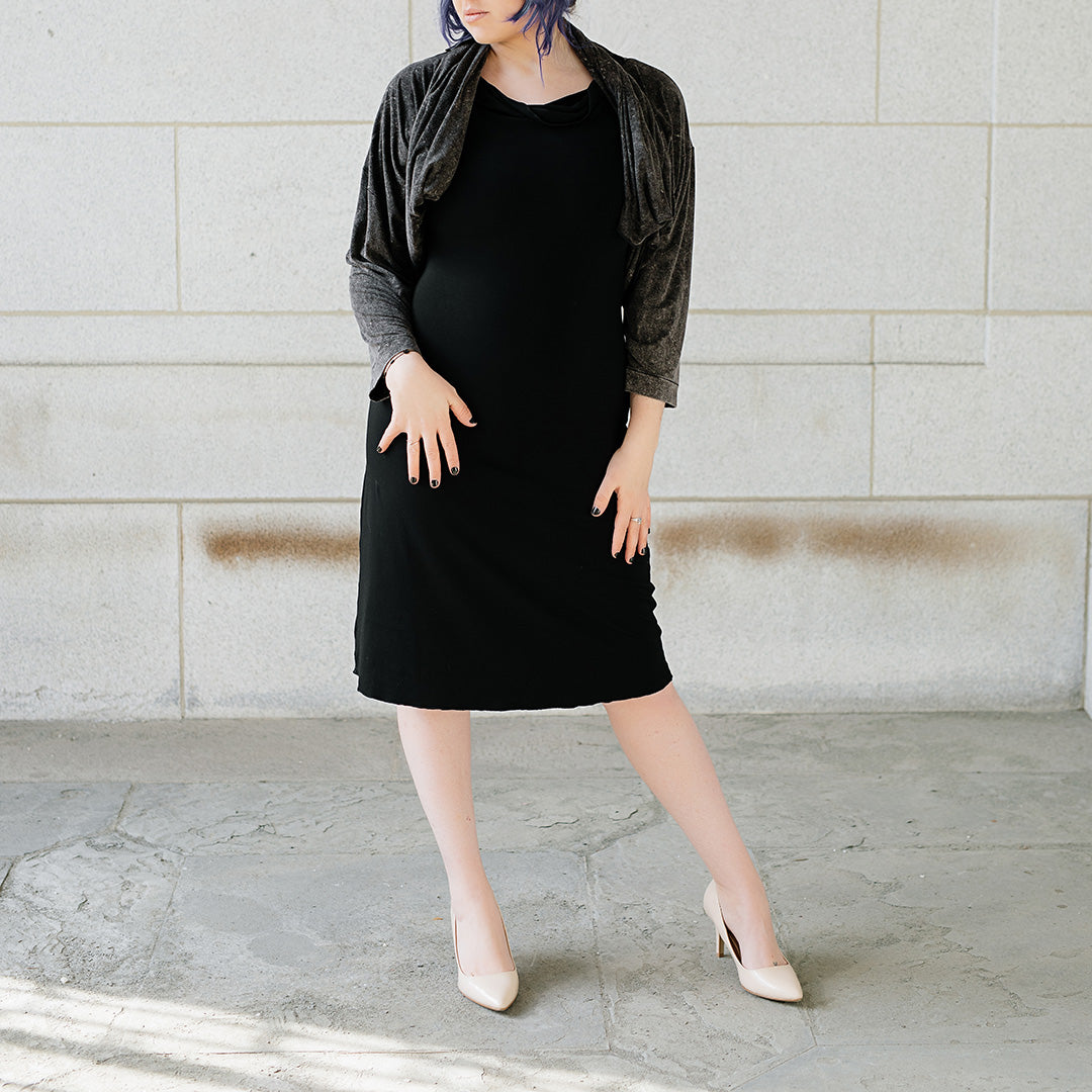 graceful dress in black with mineral prima jacket worn with ends tied and looped around neck