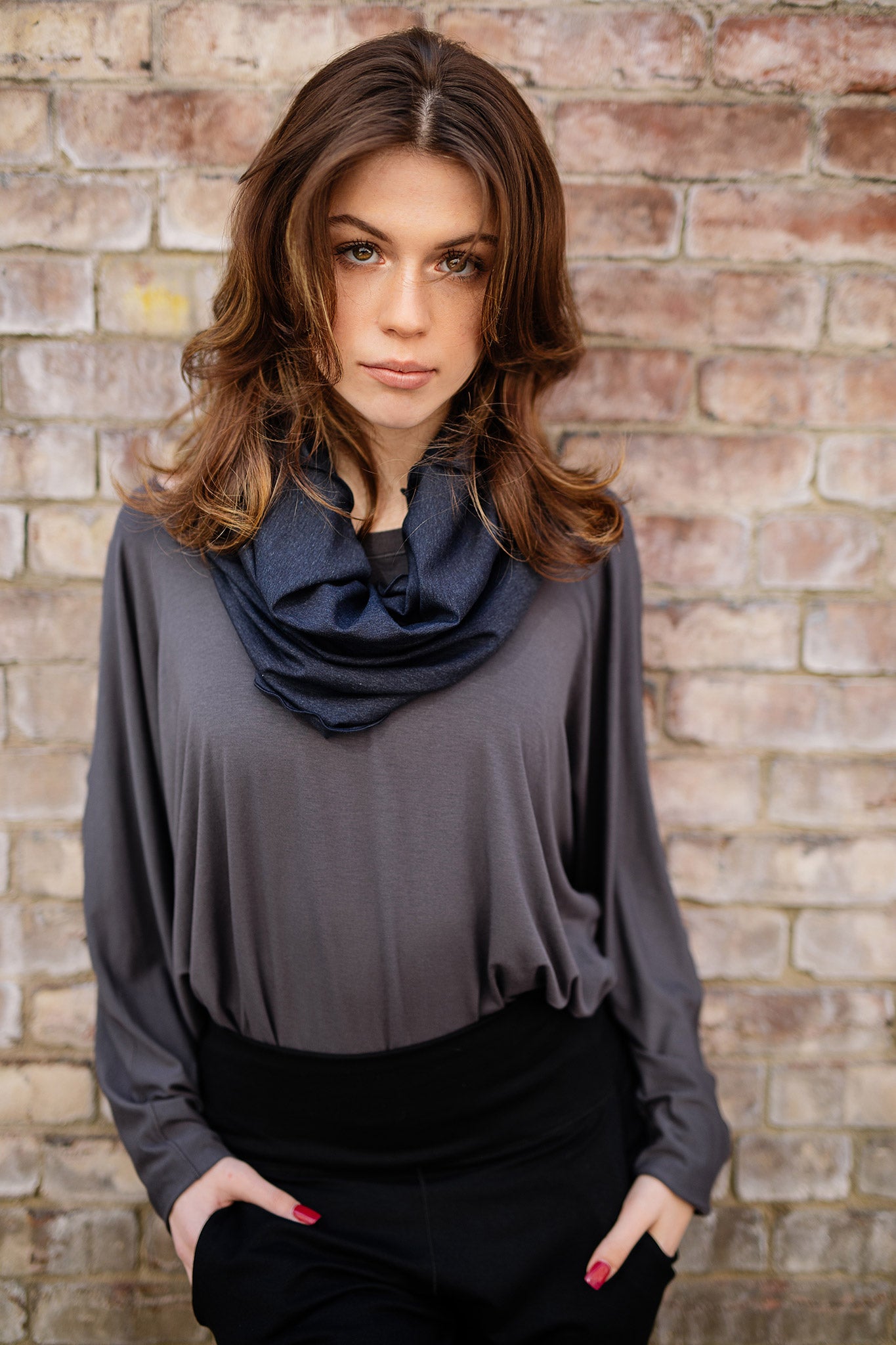 pop top in carbon worn tucked into black joggers with midnight hourglass around neck