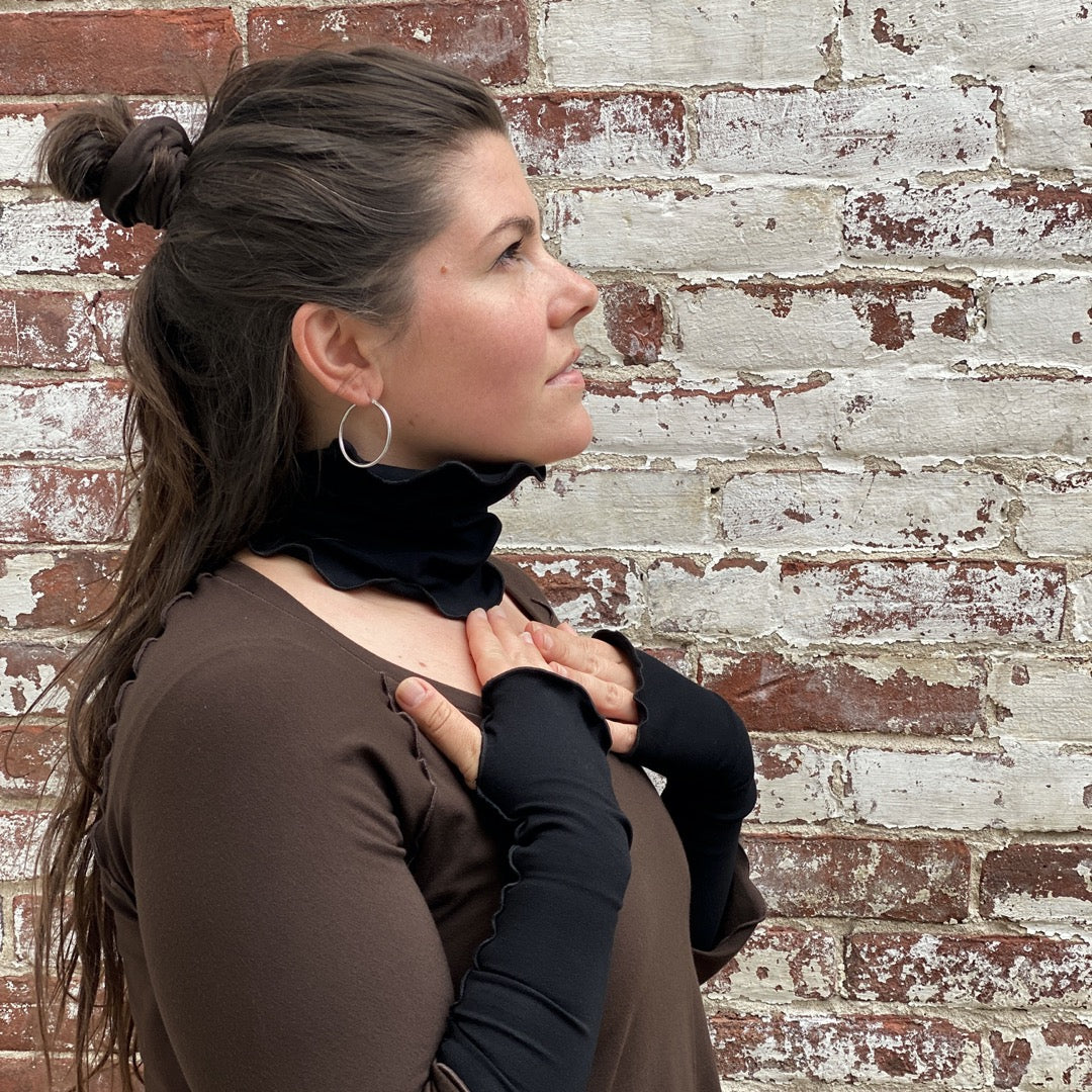 matching band worn at neck and opera sleeves, shown in black