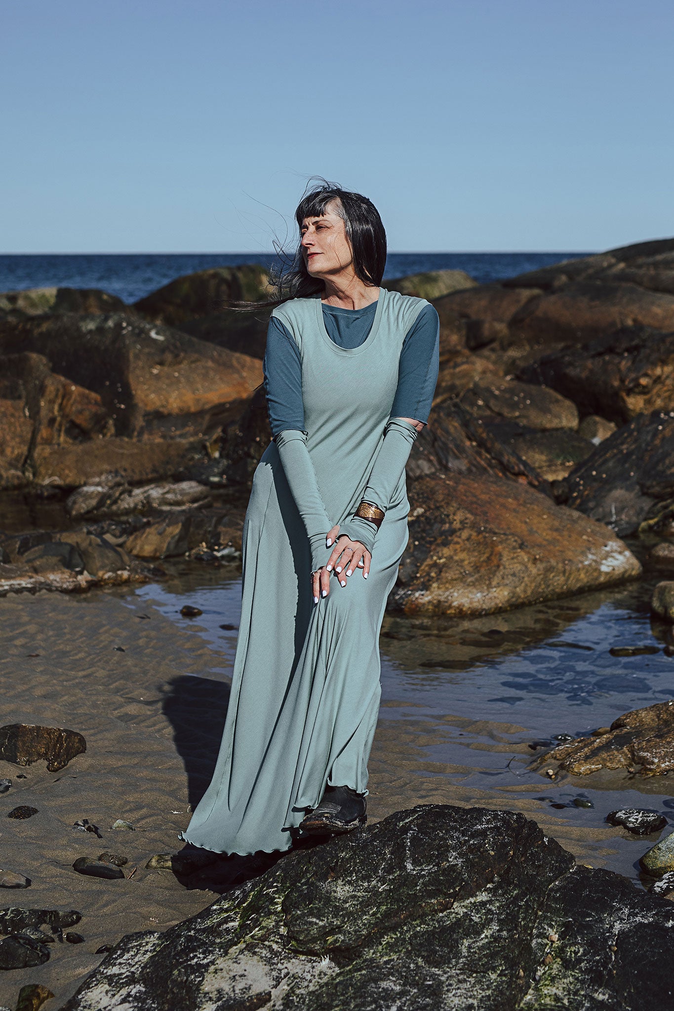 glow gown in glass worn over rose top in ocean with glass opera sleeves