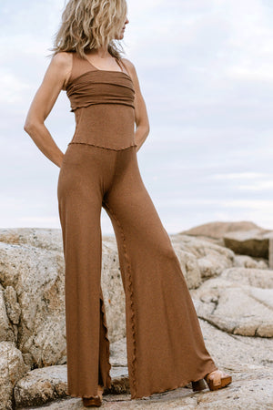 suger® swirlsuit in almond pulled up to chest