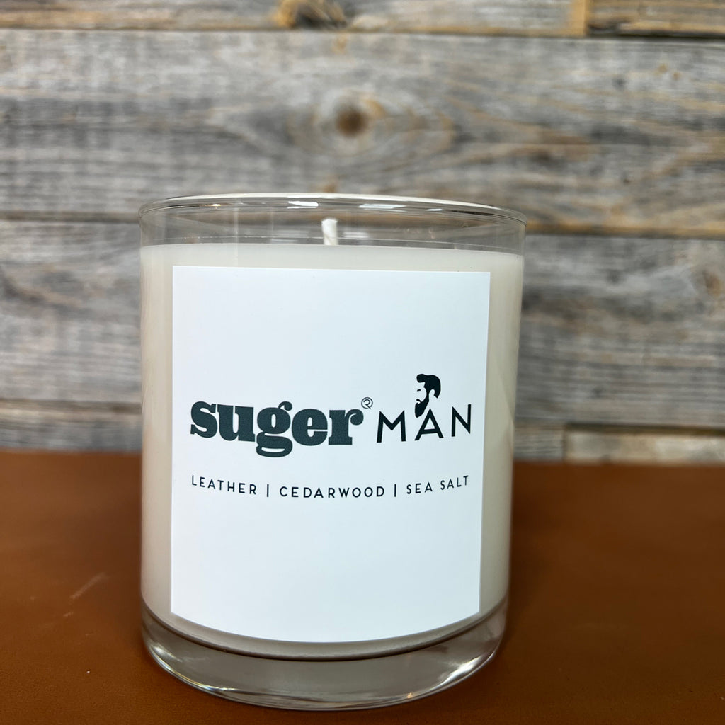 sugerman signature suger candle with scents of leather, cedarwood, and sea salt