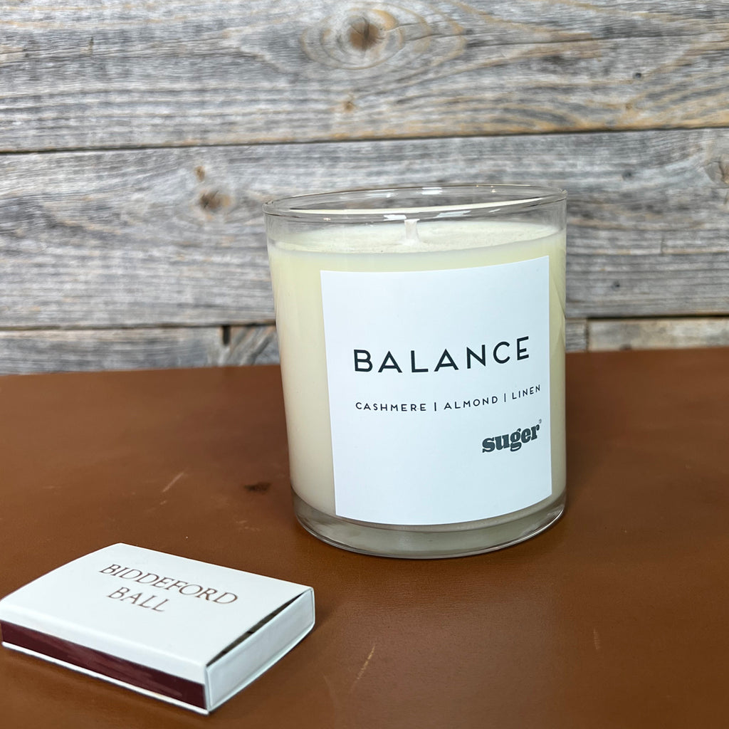 signature suger candle called balance with scents of cashmere, almond and linen