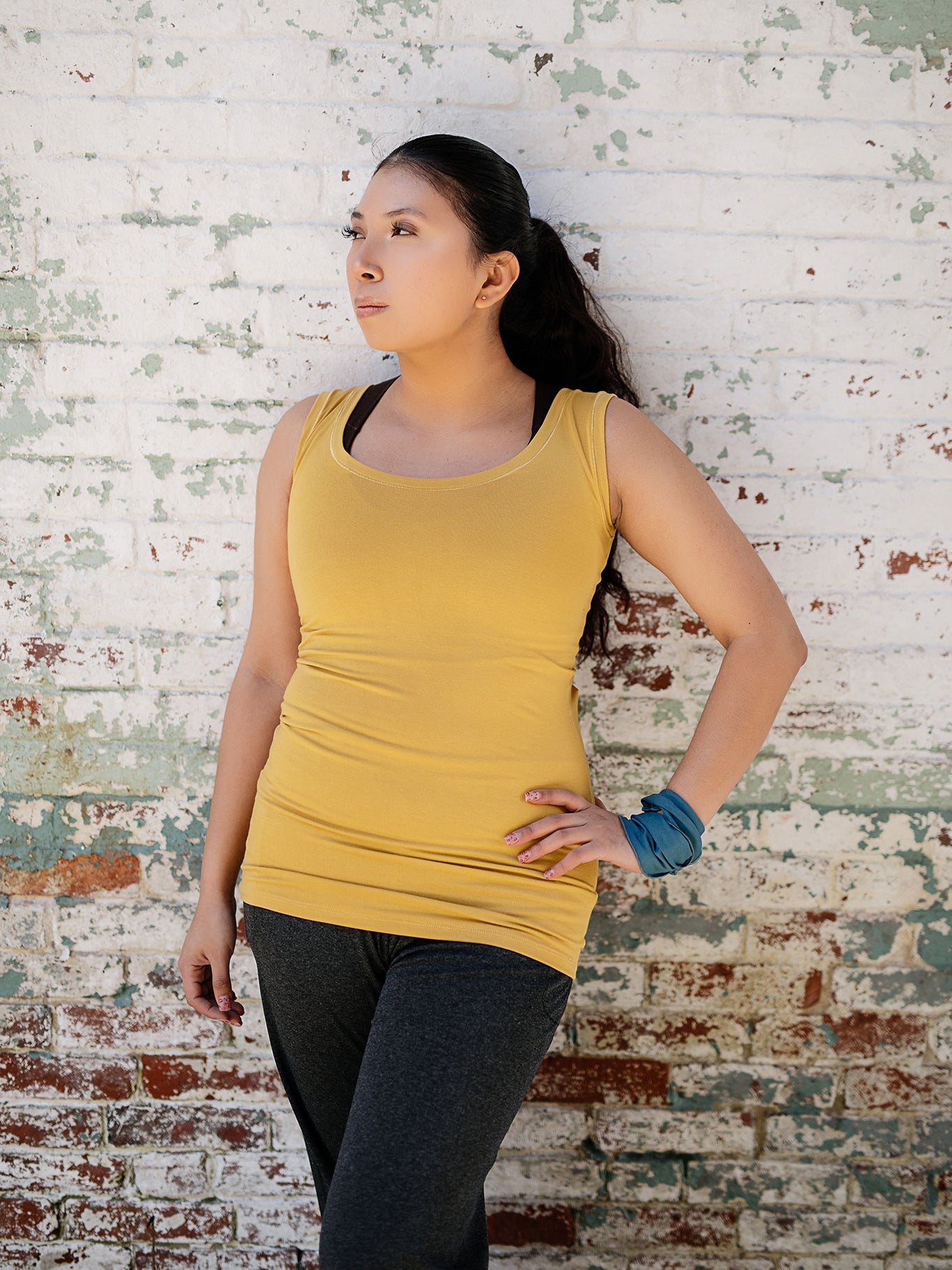core essential tank in amber with charcoal kick pant and ocean band around wrist