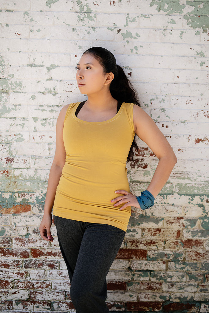 core essential tank in amber with charcoal kick pant and ocean band around wrist