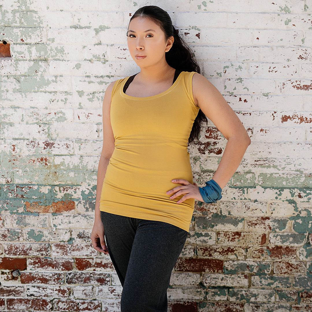 core essential tank in amber with charcoal kick pant and ocean band around wrist