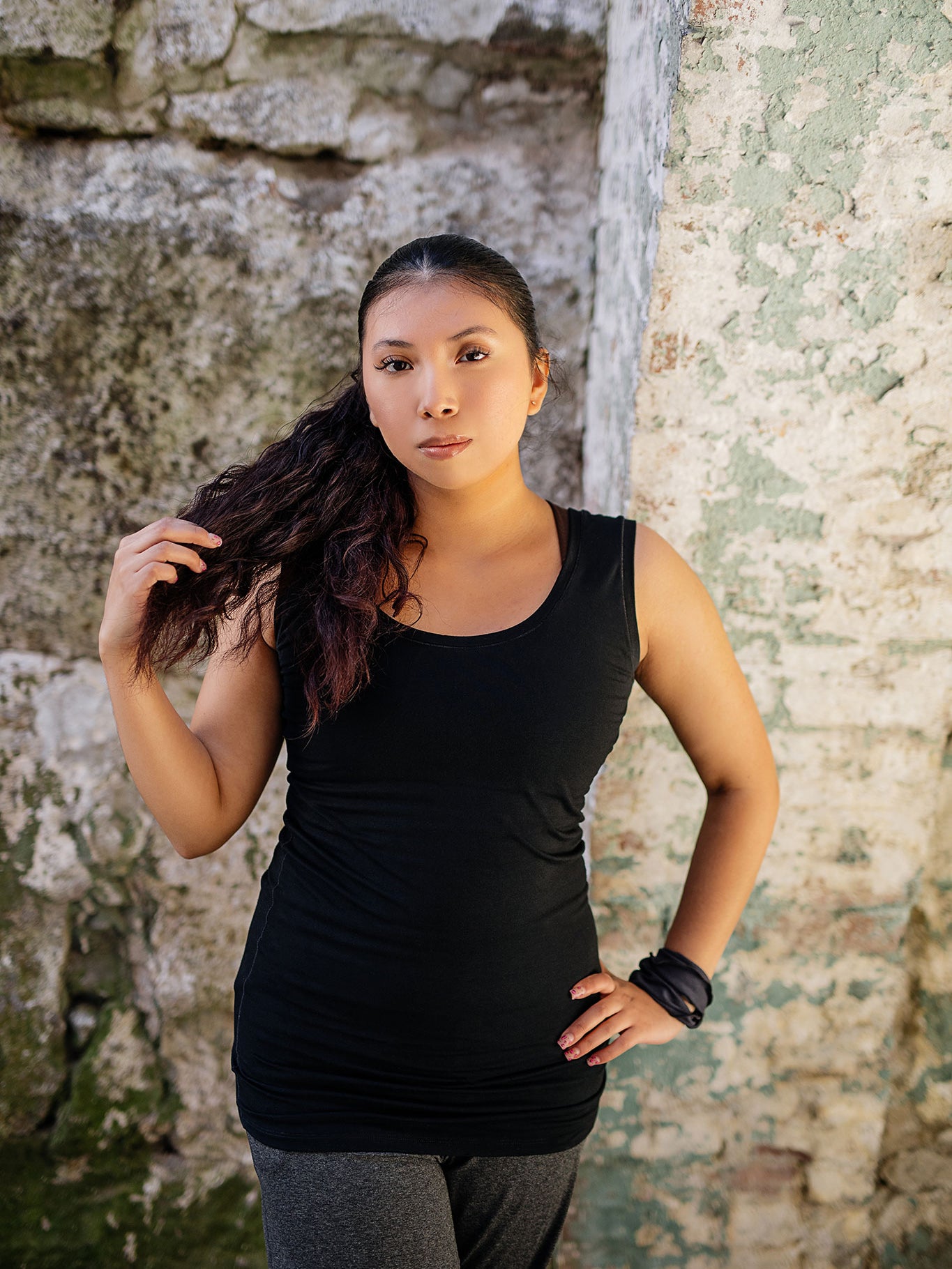 core essential tank in black with charcoal kick pant and carbon band around wrist