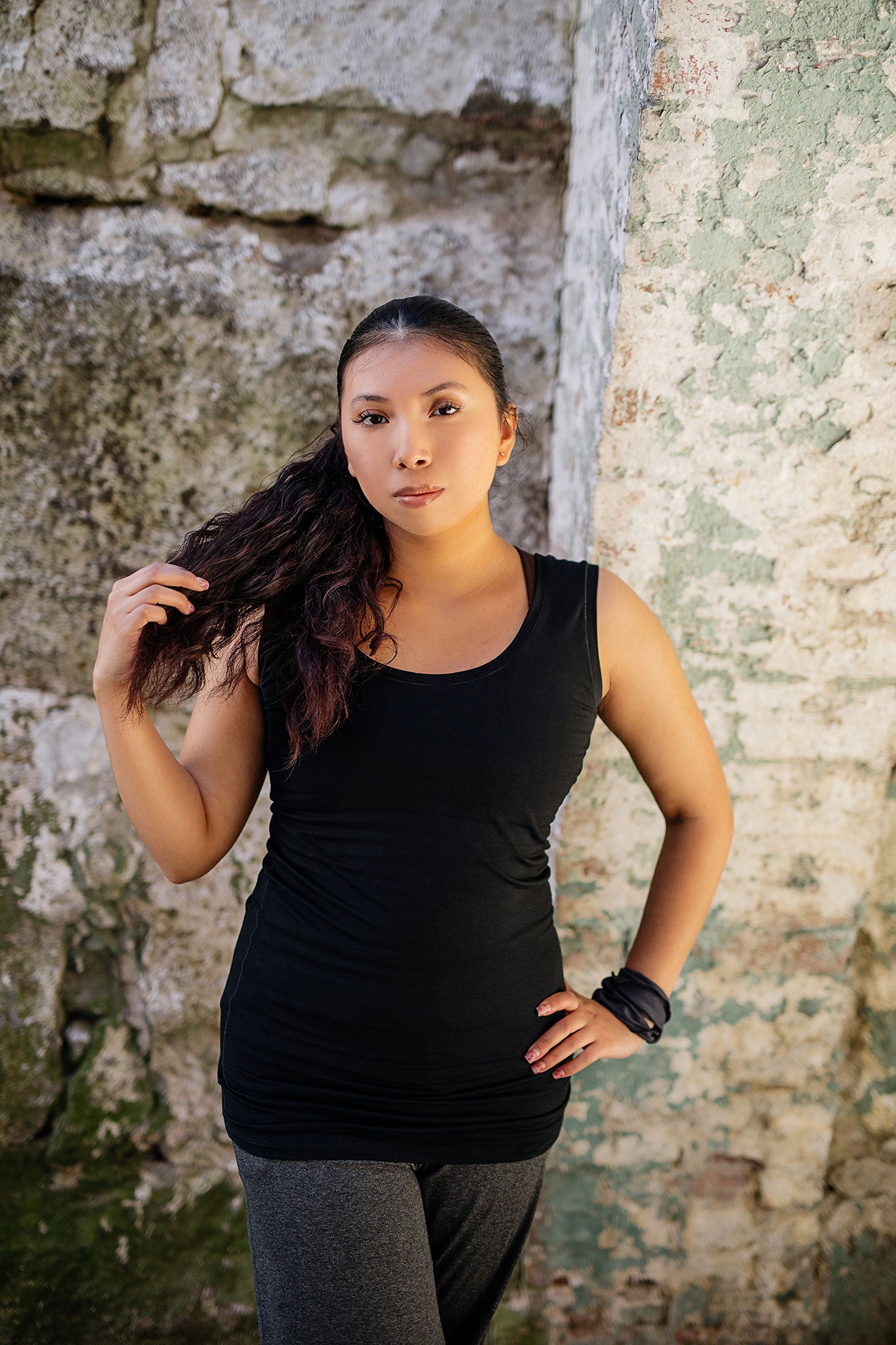 core essential tank in black with charcoal kick pant and carbon band around wrist