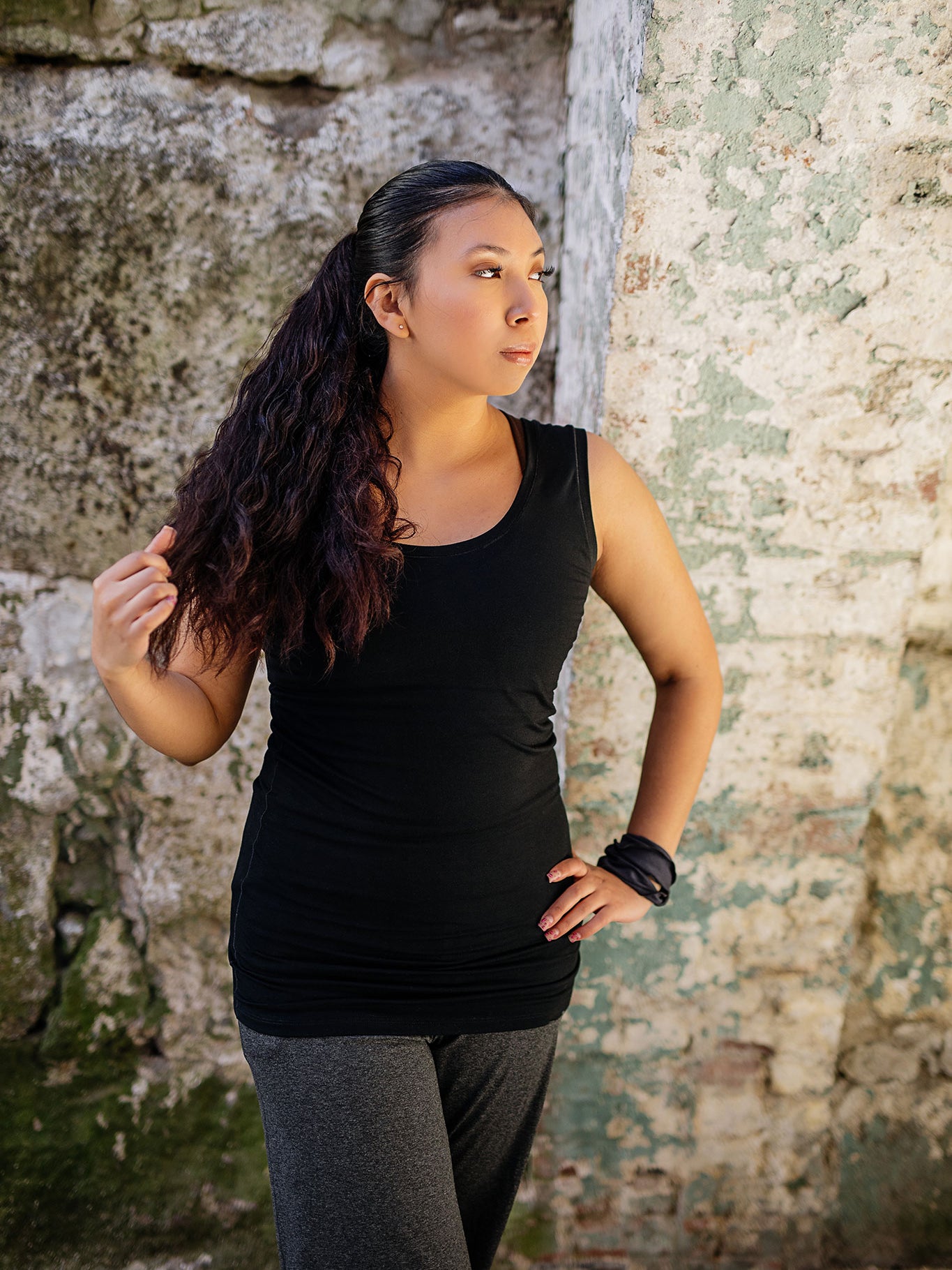 core essential tank in black with charcoal kick pant and charcoal band around wrist