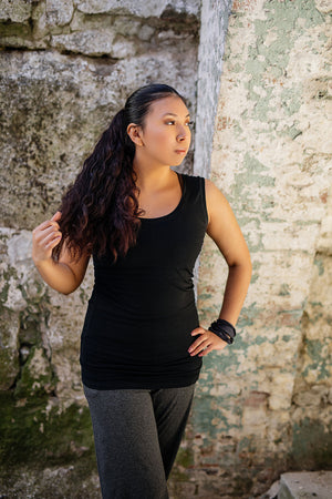 core essential tank in black with charcoal kick pant and charcoal band around wrist