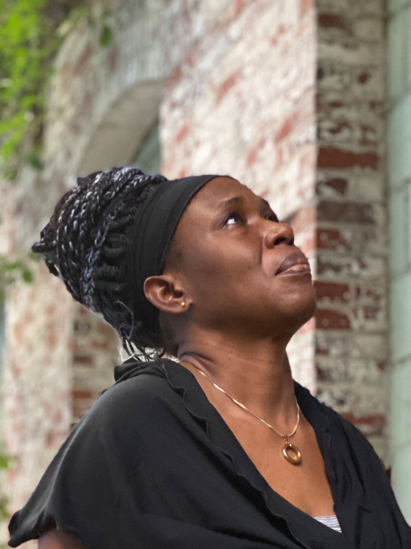 regal Toto wearing a black band and loop scarf