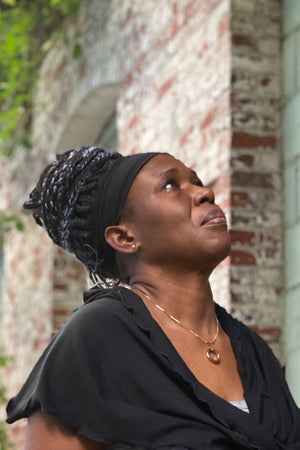 regal Toto wearing a black band and loop scarf