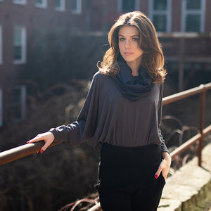 pop top in carbon worn tucked into black joggers with midnight hourglass around neck