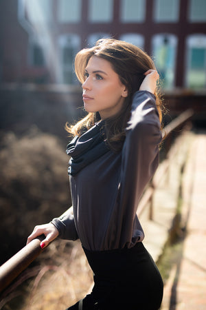 pop top in carbon worn tucked into black joggers with midnight hourglass around neck