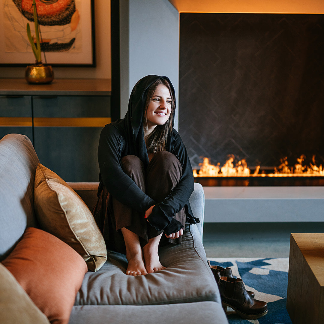 cardi in black with hood up paired with black opera sleeves and harlow pant in peat