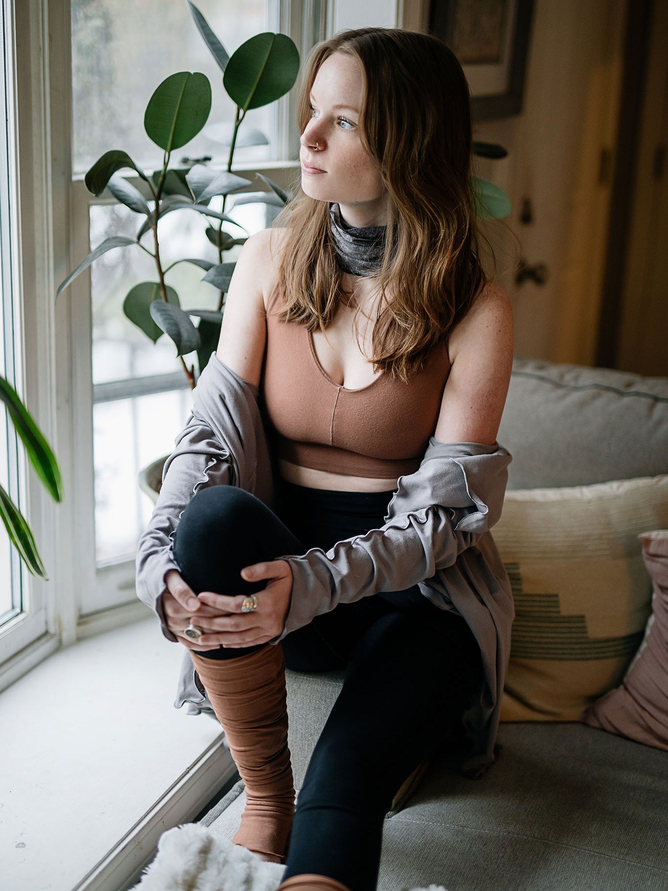 balance bra in cedar paired with cardi jacket in moon, black playsuit, and cedar stockings