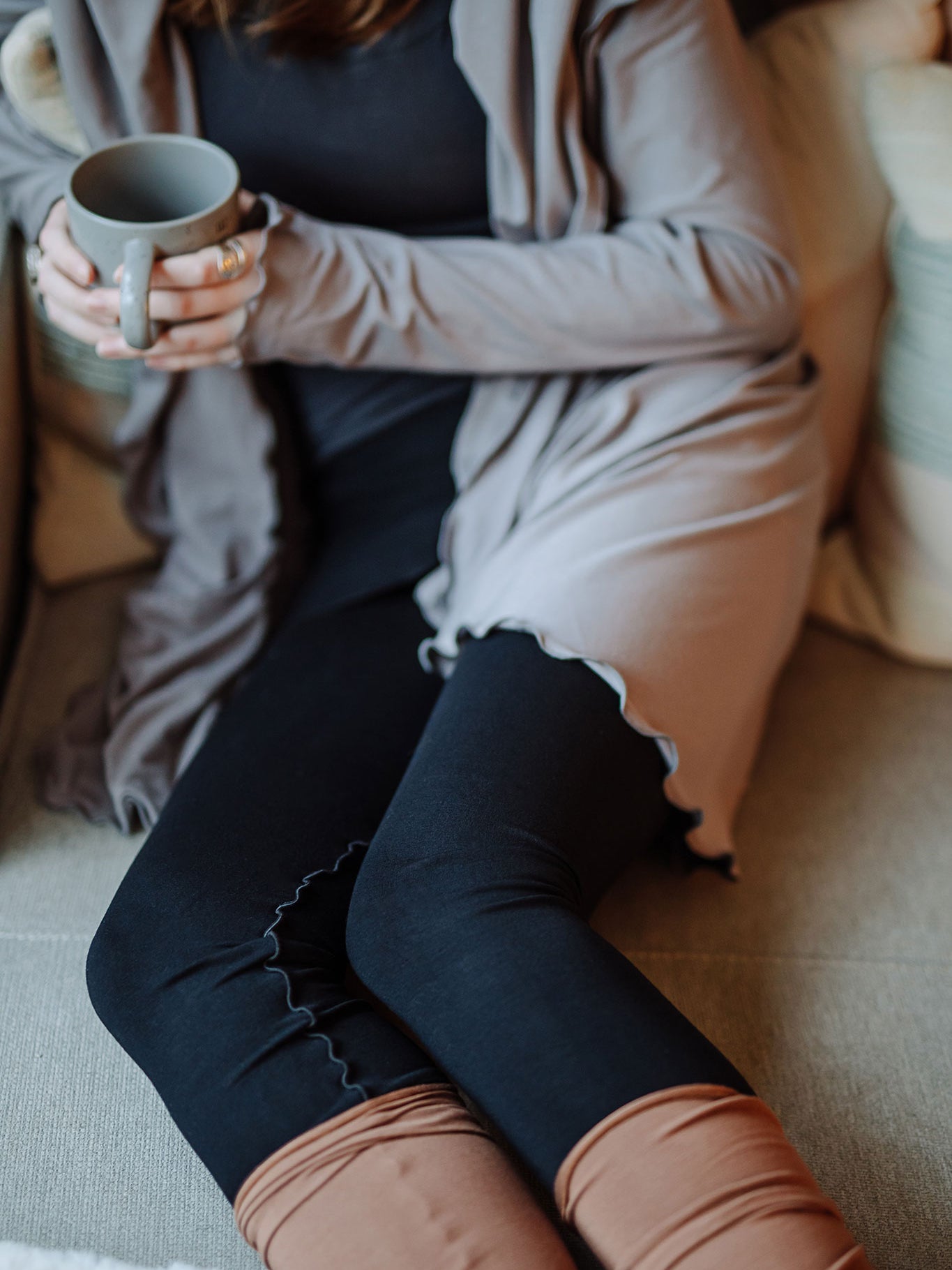playsuit in black with top section folded over into a skirt; paired with cardi jacket in moon, cedar stockings, and core tank in carbon