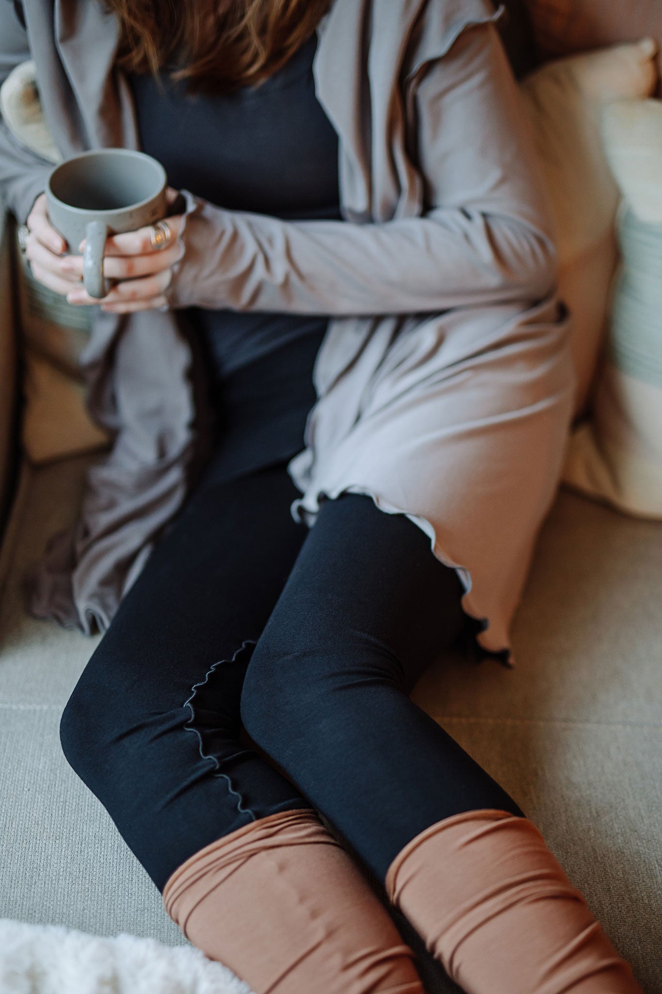 playsuit in black with top section folded over into a skirt; paired with cardi jacket in moon, cedar stockings, and core tank in carbon