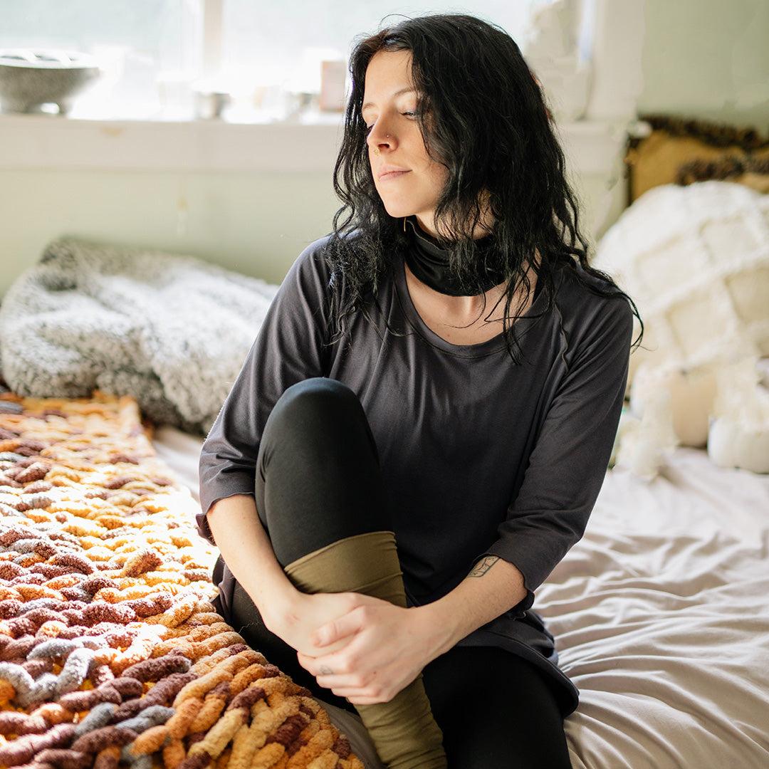 swing top in carbon with black base leggings, black band around neck, and olive stockings