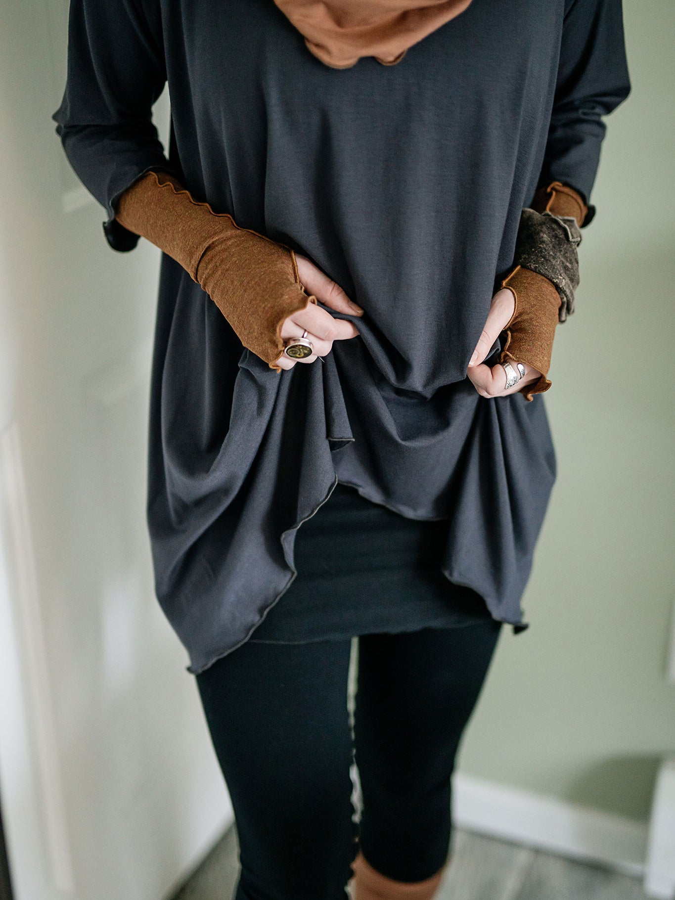 swing top in carbon paired with black playsuit, cedar hourglass around neck, and almond aria gloves