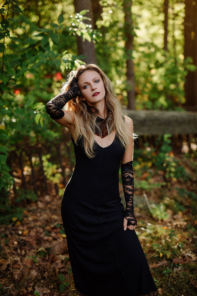 goddess dress in subtle black with black lace opera sleeves and spice mineral hourglass at neck