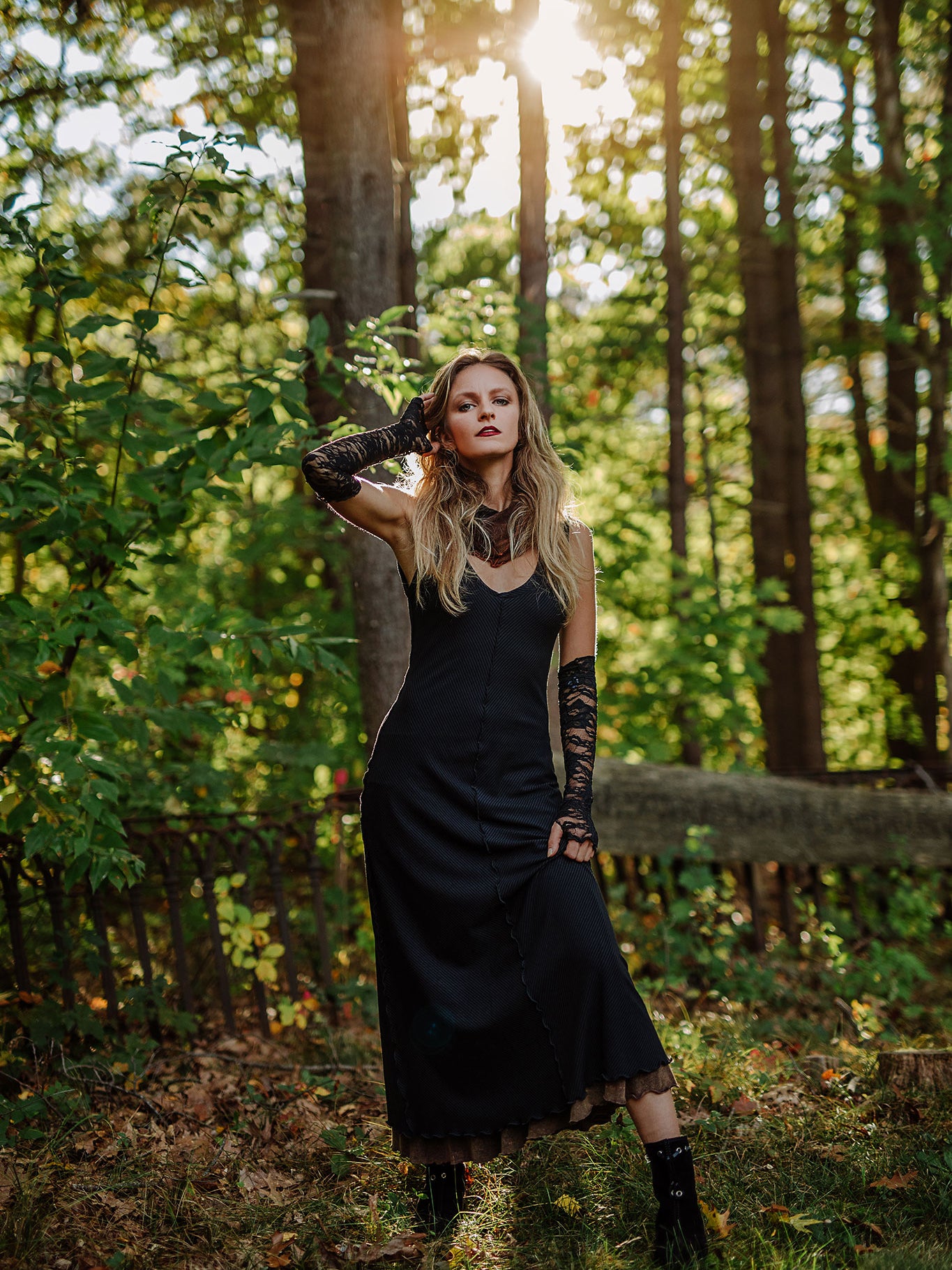 goddess dress in subtle black with black lace opera sleeves and spice mineral hourglass at neck