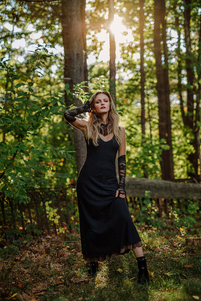 goddess dress in subtle black with black lace opera sleeves and spice mineral hourglass at neck