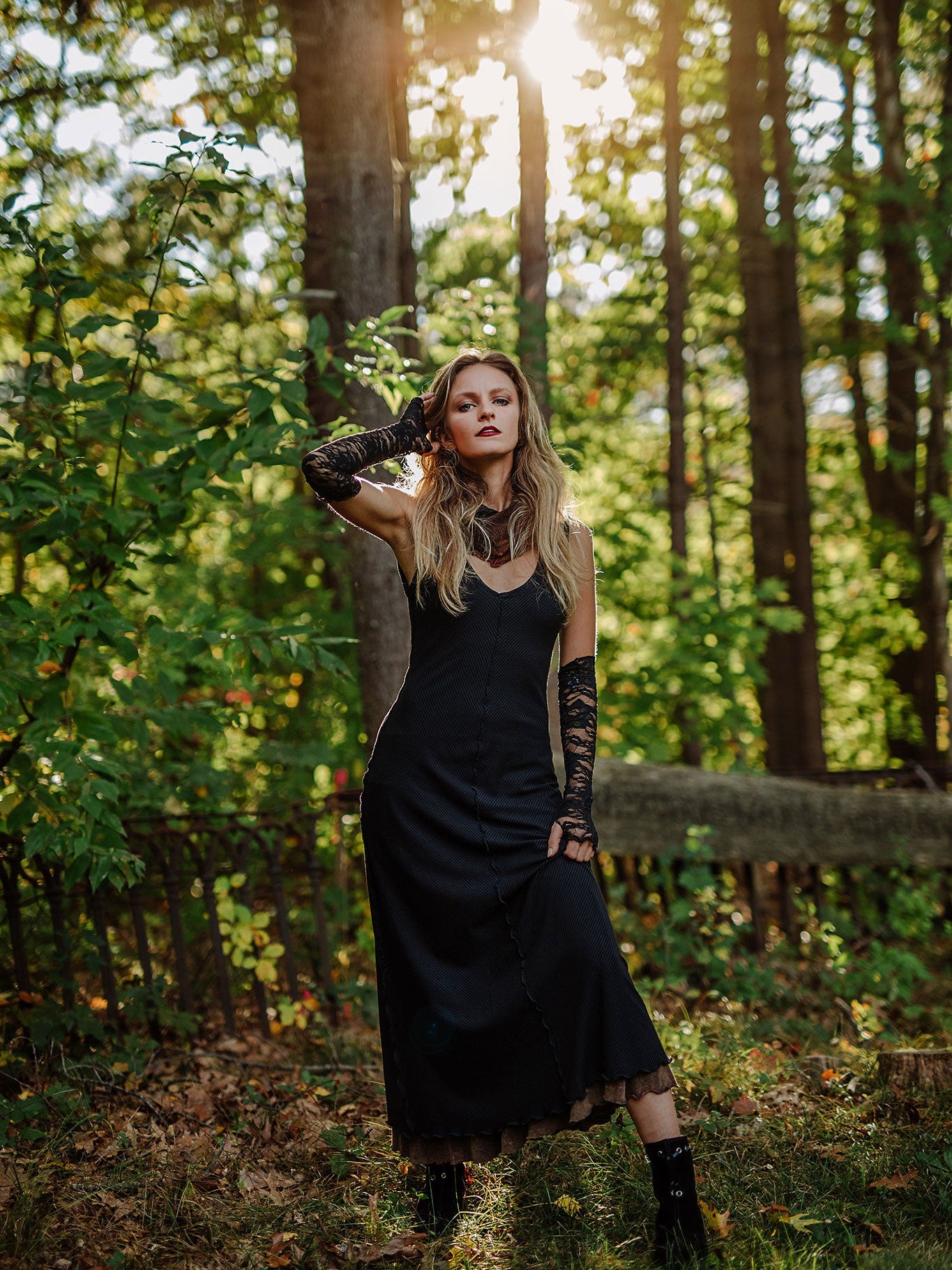 goddess dress in subtle black with black lace opera sleeves and spice mineral hourglass at neck