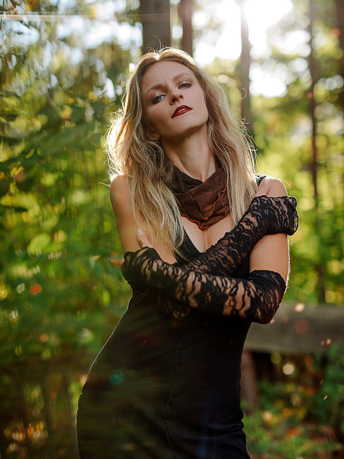 goddess dress in subtle black with black lace opera sleeves and spice mineral hourglass at neck