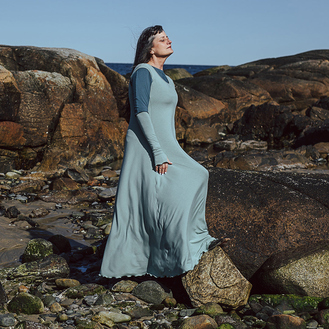 glow gown in glass worn over rose top in ocean with glass opera sleeves