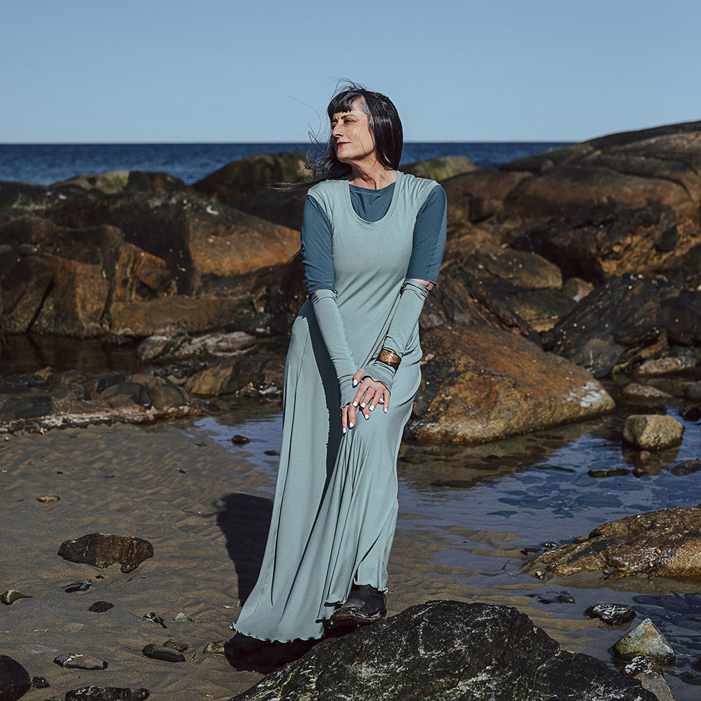 glow gown in glass worn over rose top in ocean with glass opera sleeves