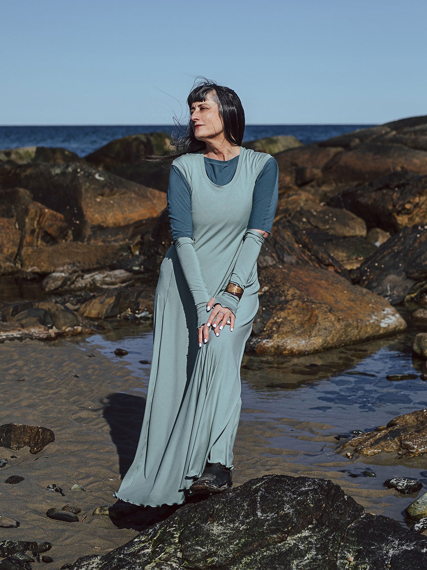 glow gown in glass worn over rose top in ocean with glass opera sleeves