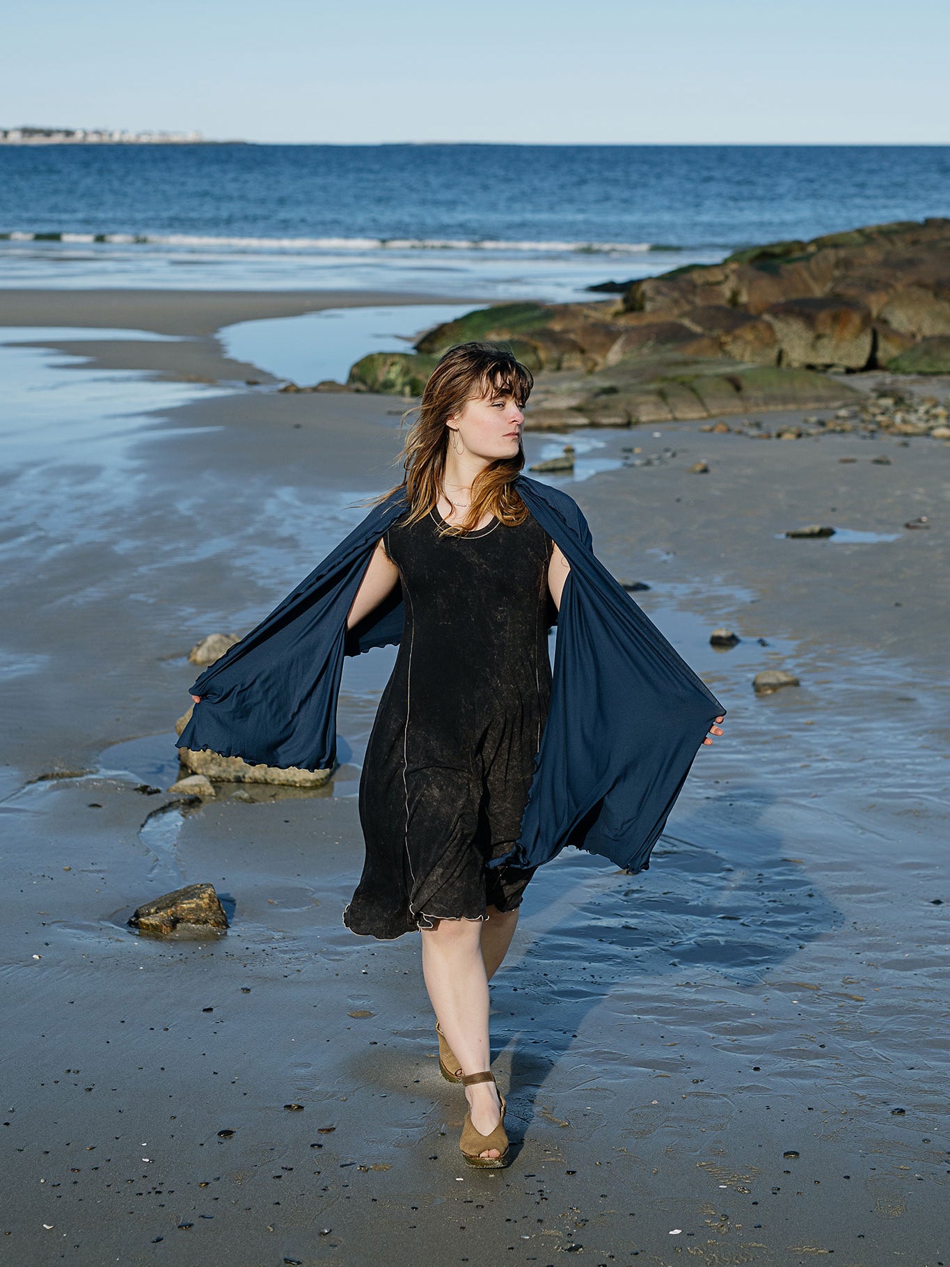 shawl in navy worn over glow dress in mineral