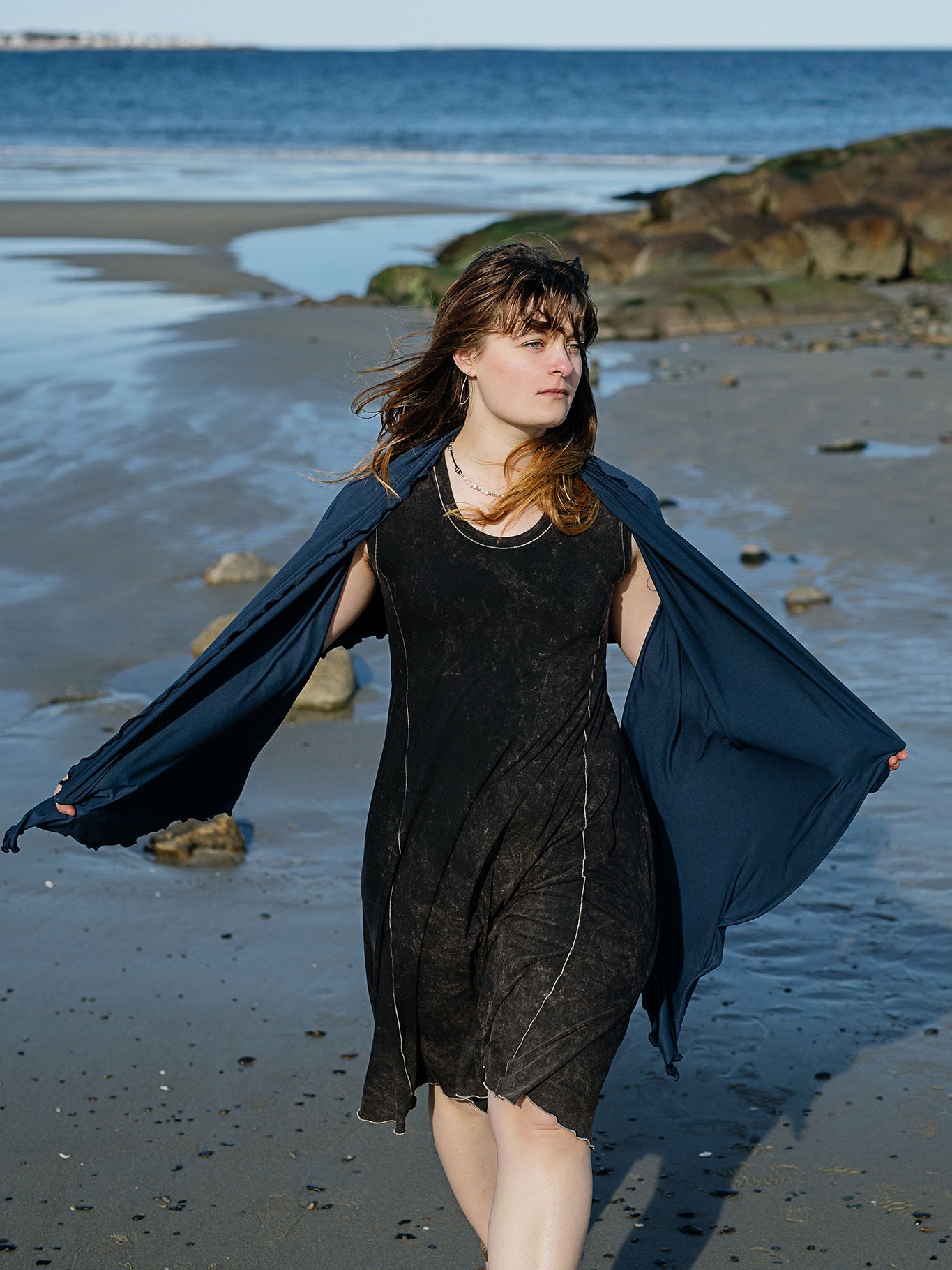 shawl in navy worn over glow dress in mineral