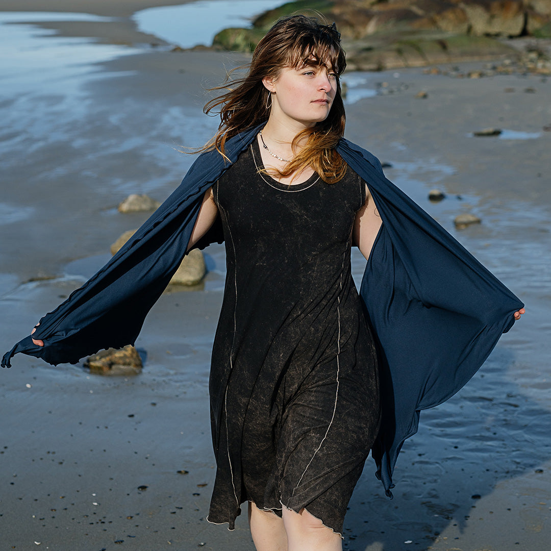 shawl in navy worn over glow dress in mineral