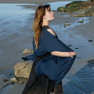 shawl in navy worn over glow dress in mineral