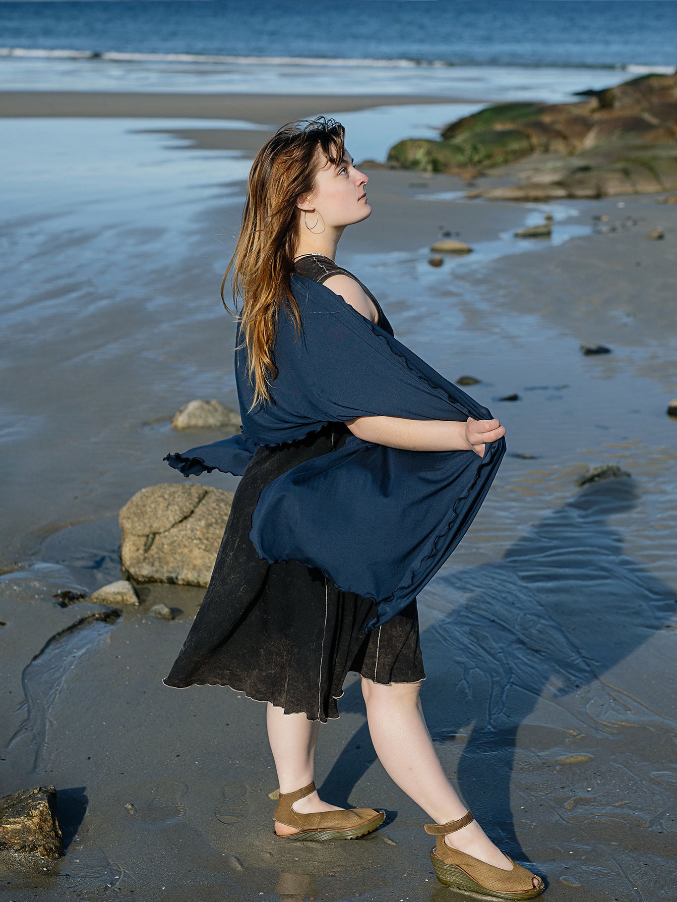 shawl in navy worn over glow dress in mineral