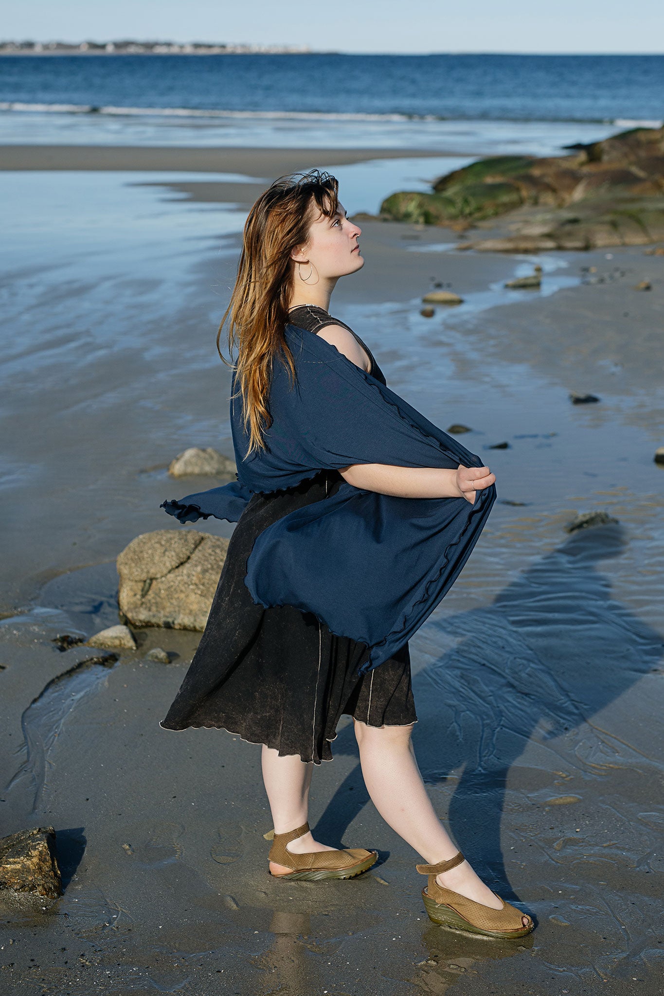 shawl in navy worn over glow dress in mineral