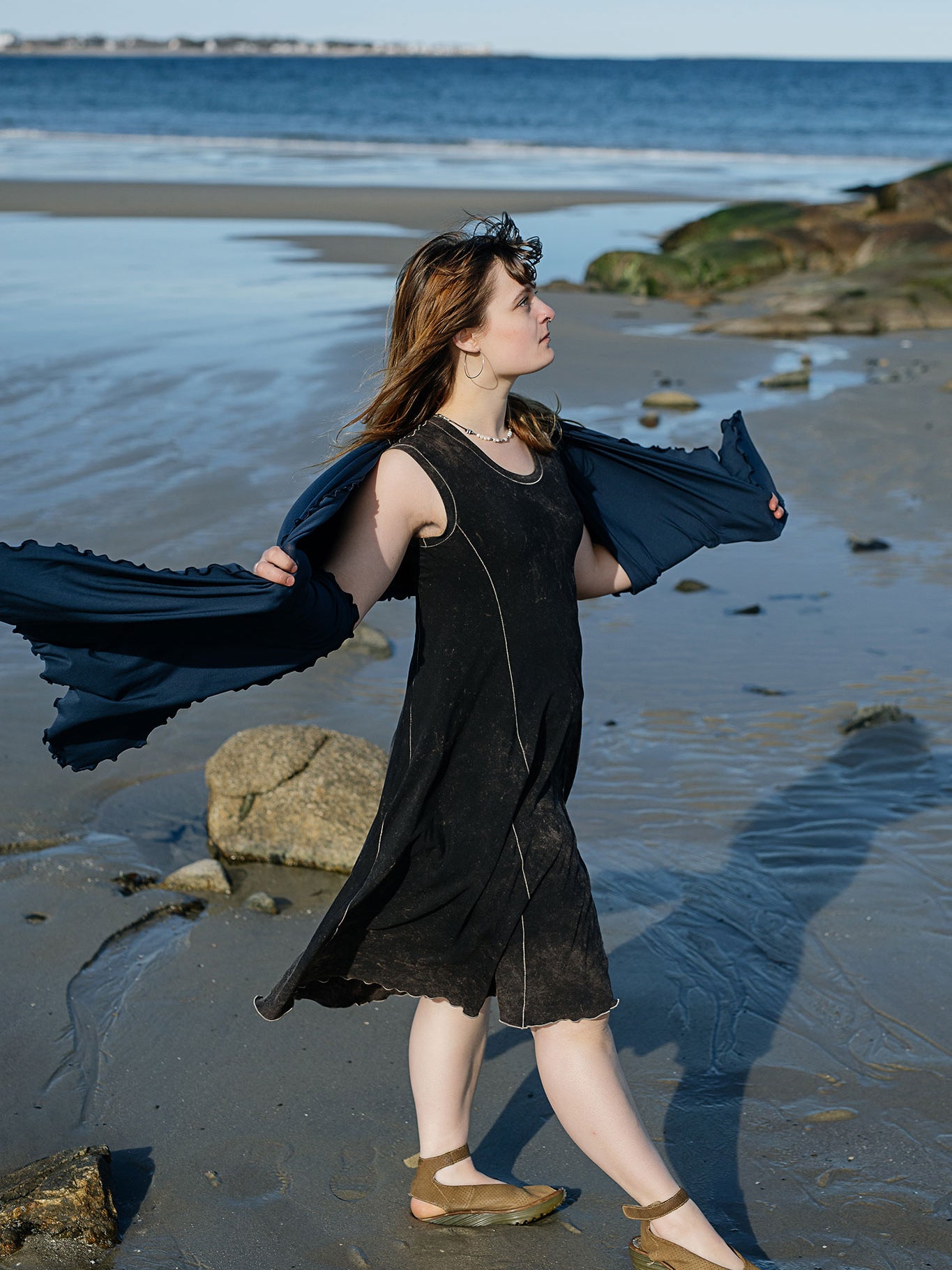 shawl in navy worn over glow dress in mineral