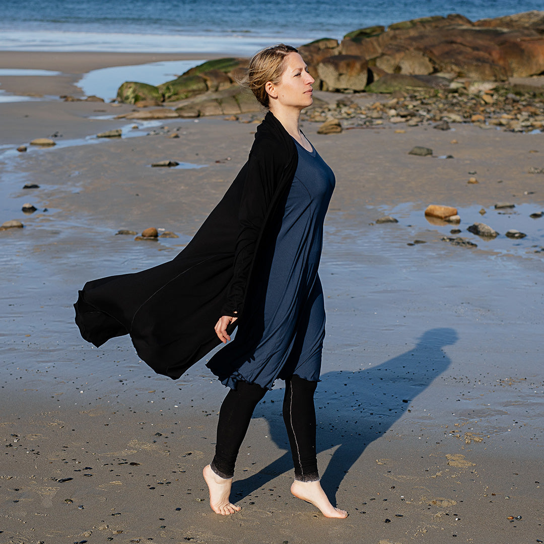 garden coat in black worn with glow dress in navy