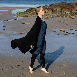 garden coat in black worn with glow dress in navy