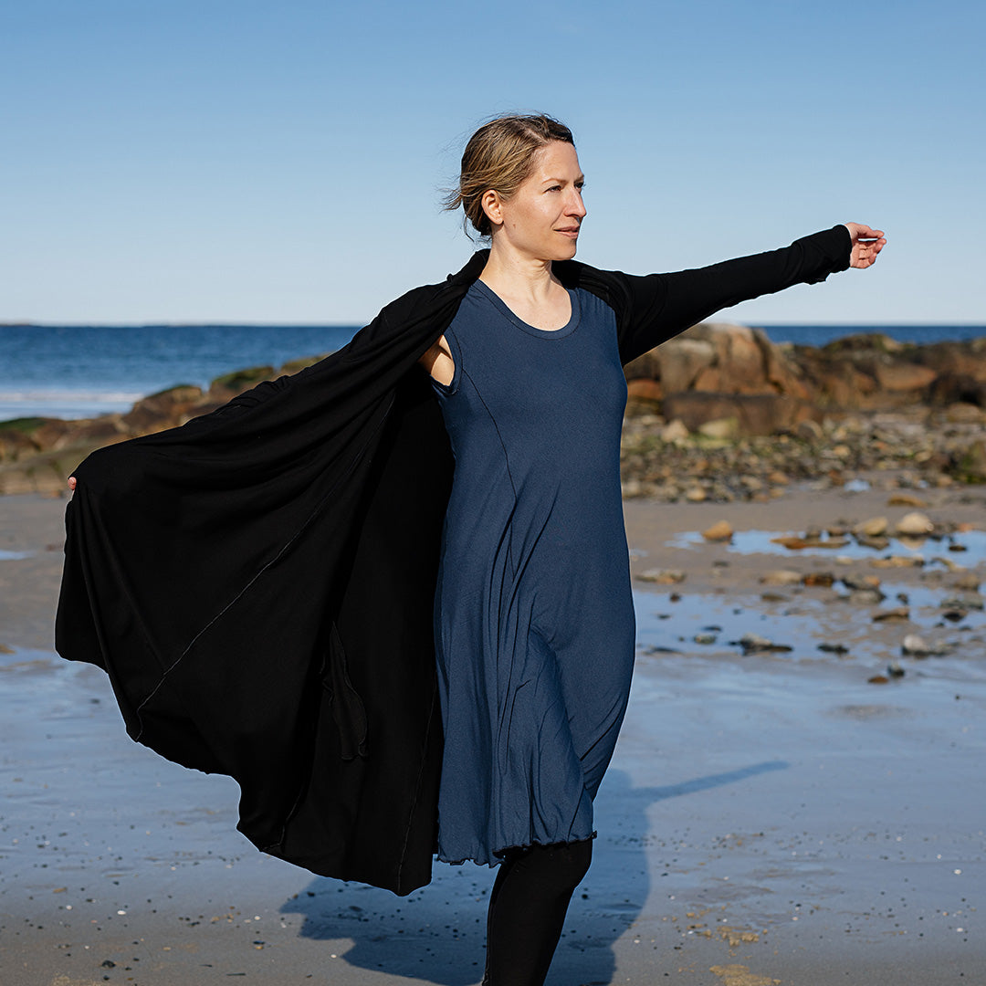 garden coat in black worn with glow dress in navy