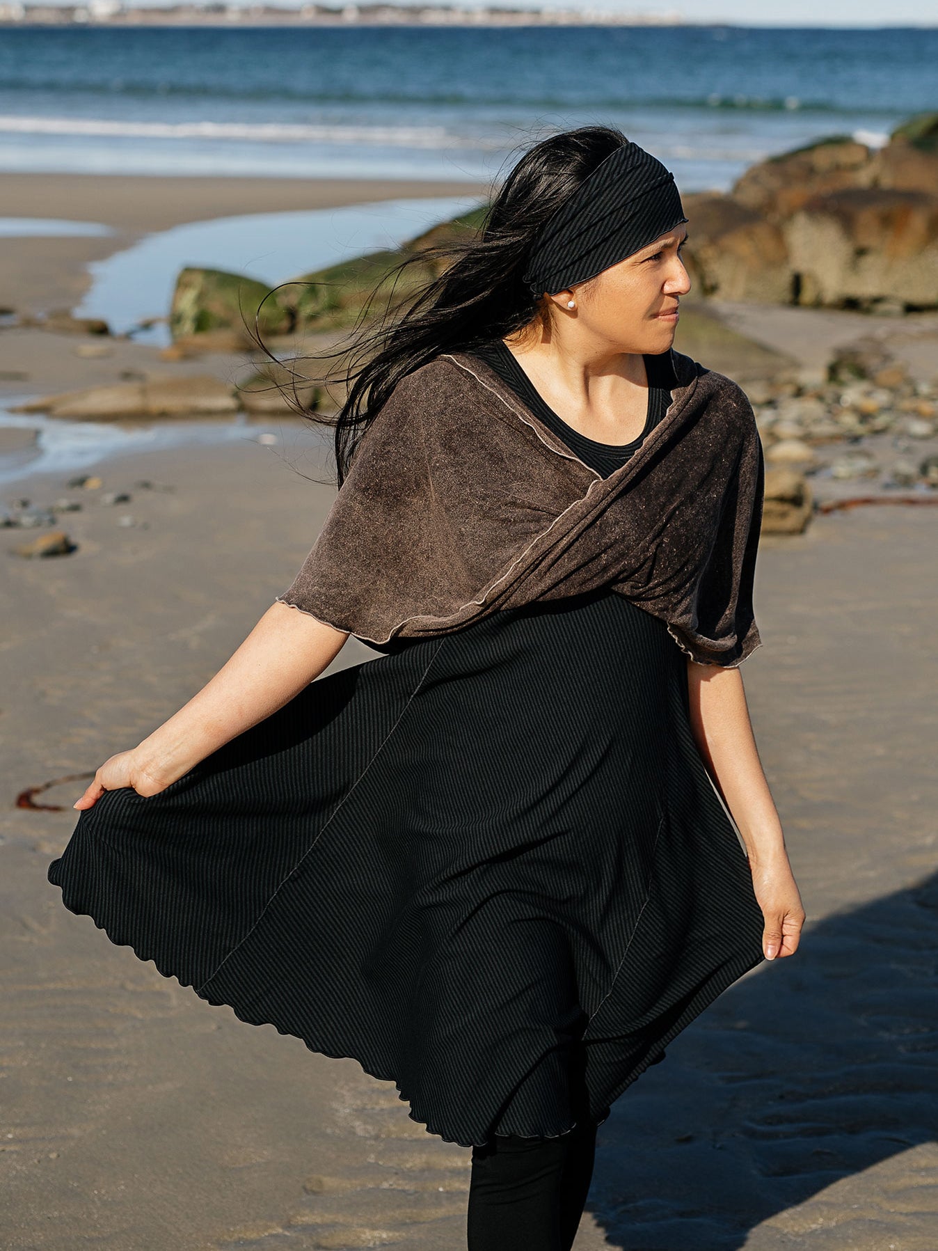 glow dress in subtle black with loop in warm mineral worn as a shawl