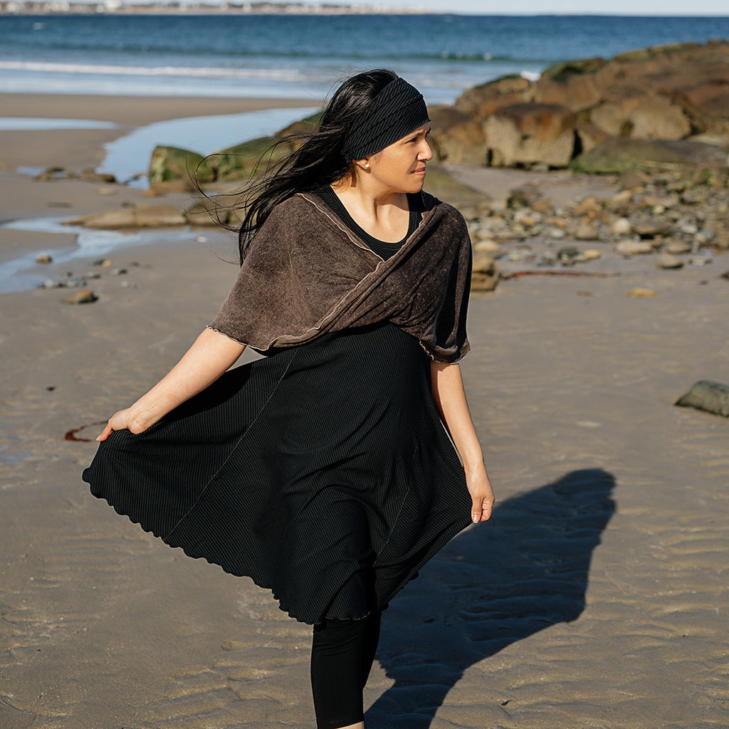 glow dress in subtle black with loop in warm mineral worn as a shawl