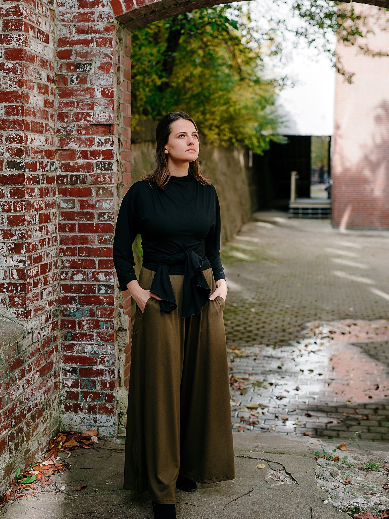 prima wrap jacket in black worn backwards and tied in the front over olive farmer