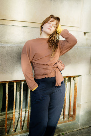 prima wrap jacket in cedar worn backwards and tied in the front over midnight harlow pant