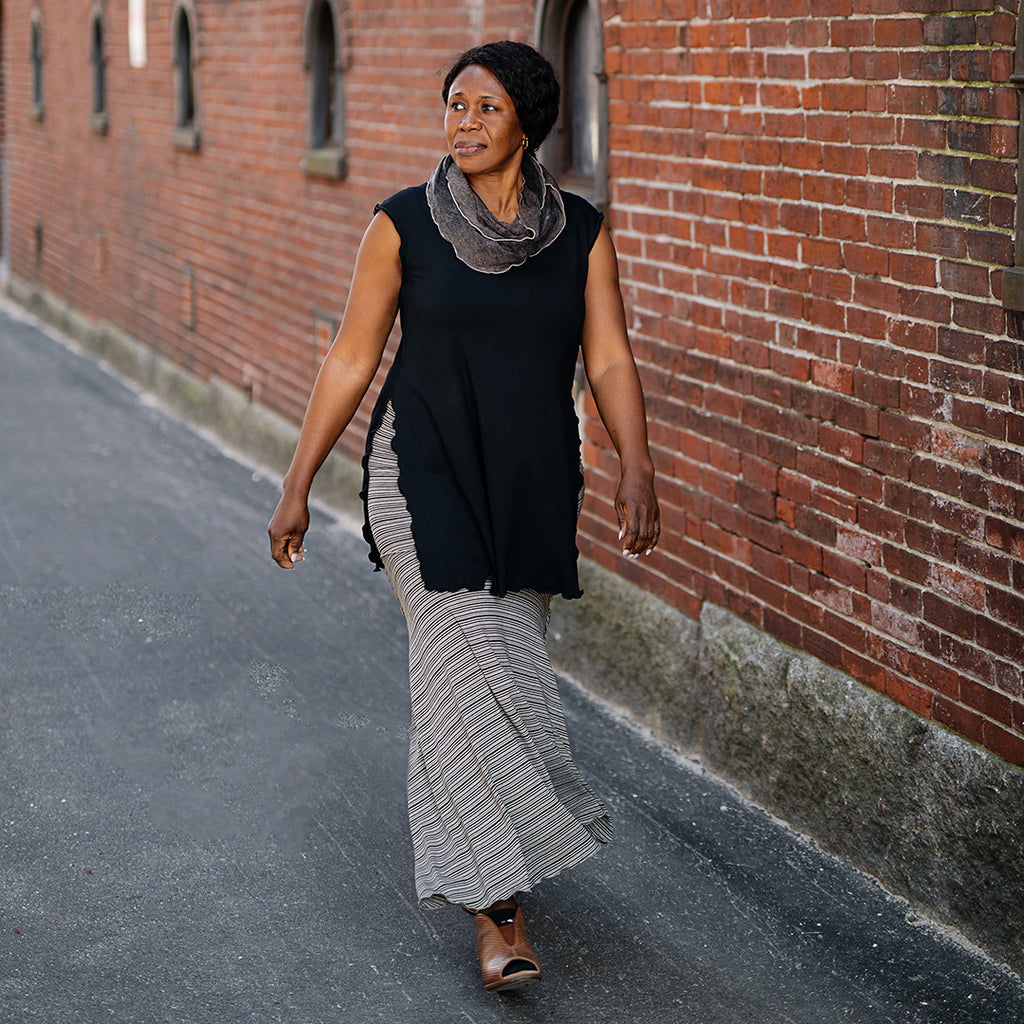 doublet layer top in black paired with mineral loop around neck and earth stripe flirt worn as a long skirt