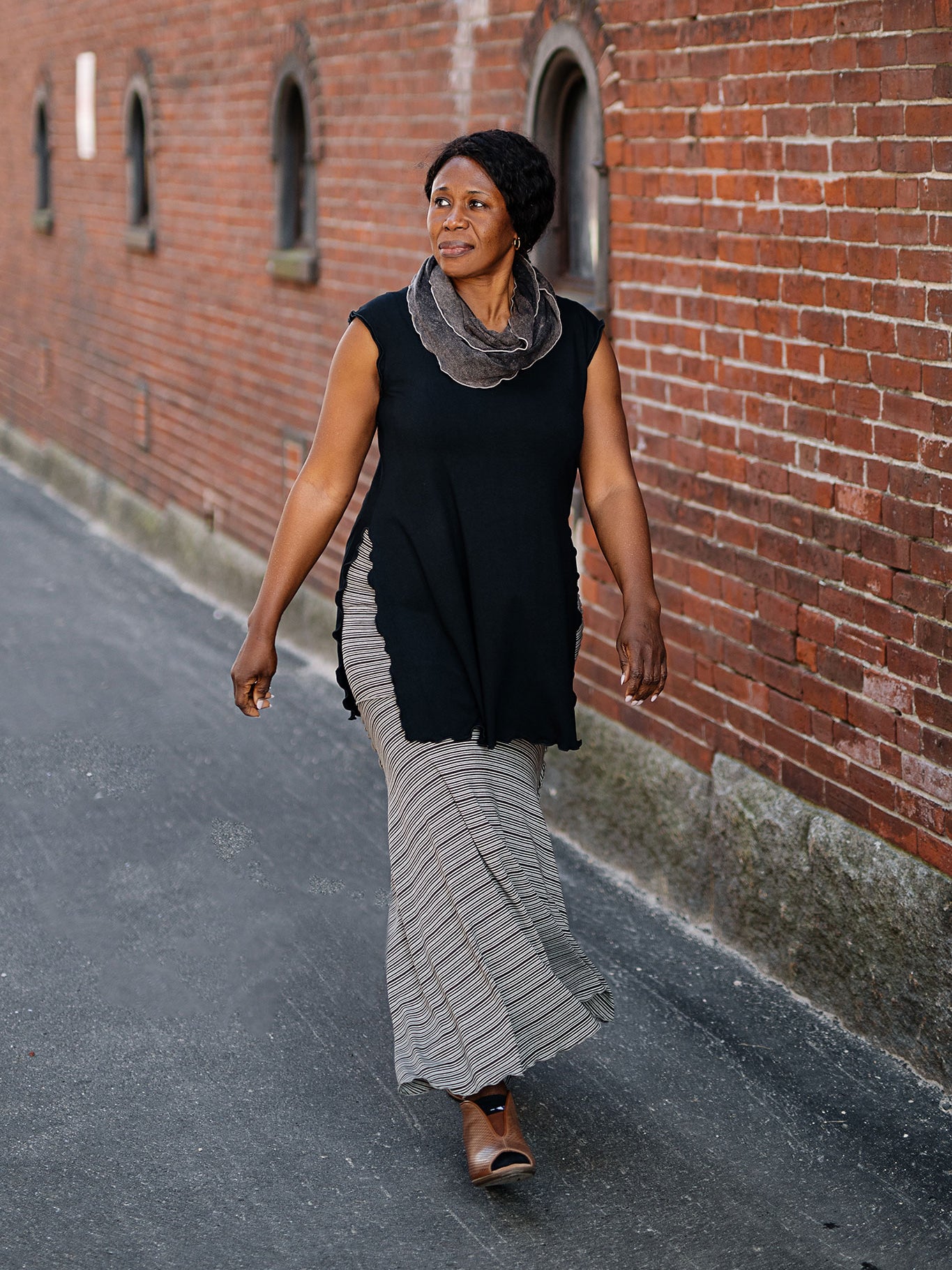 doublet layer top in black paired with mineral loop around neck and earth stripe flirt worn as a long skirt