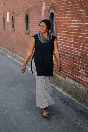 doublet layer top in black paired with mineral loop around neck and earth stripe flirt worn as a long skirt