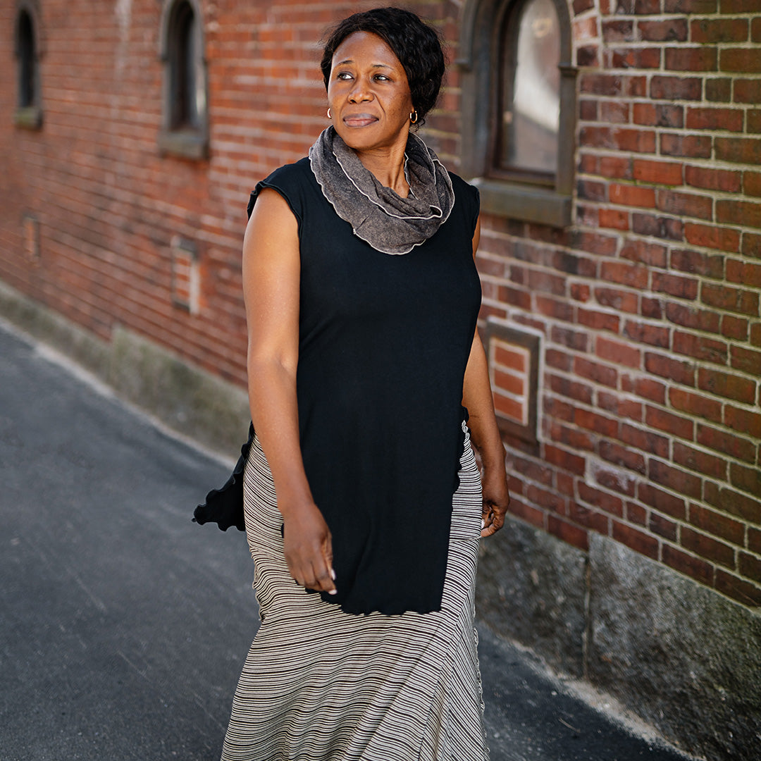 doublet layer top in black paired with mineral loop around neck and earth stripe flirt worn as a long skirt